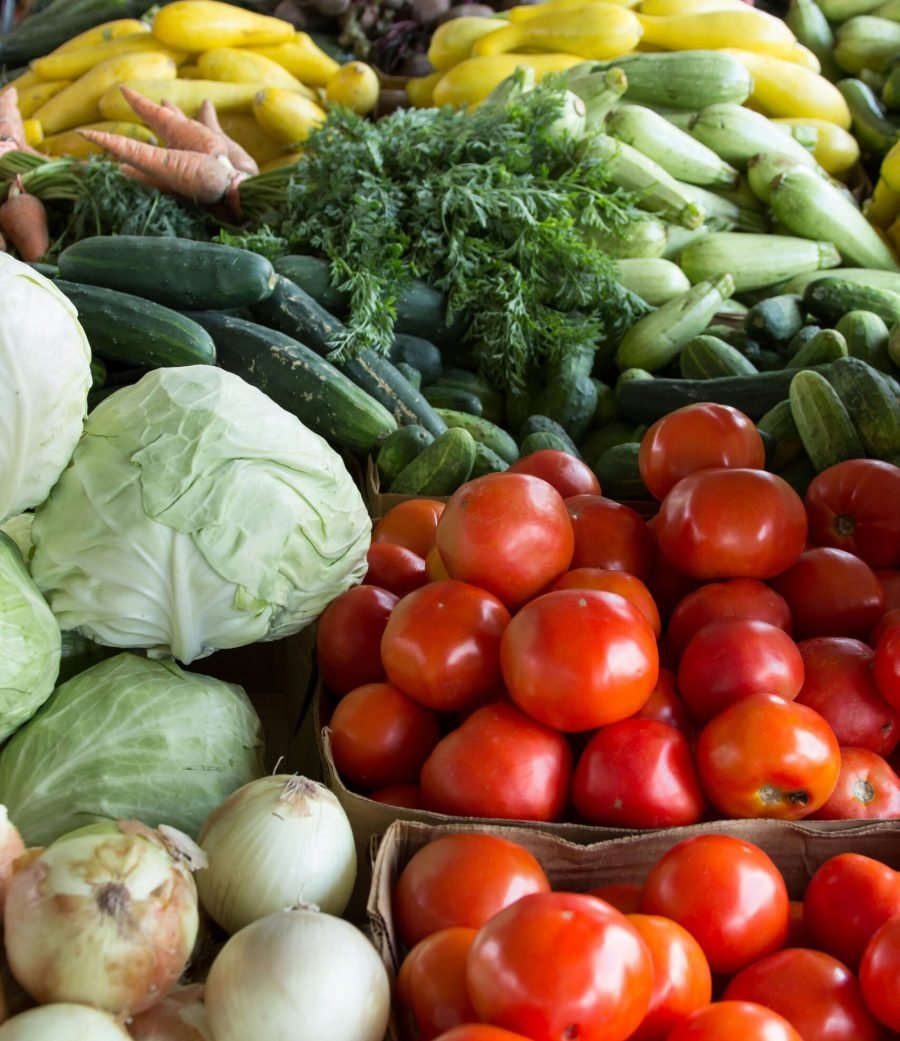 Vibrant display of organic vegetables including tomatoes, cabbages, and more at a North Carolina market.